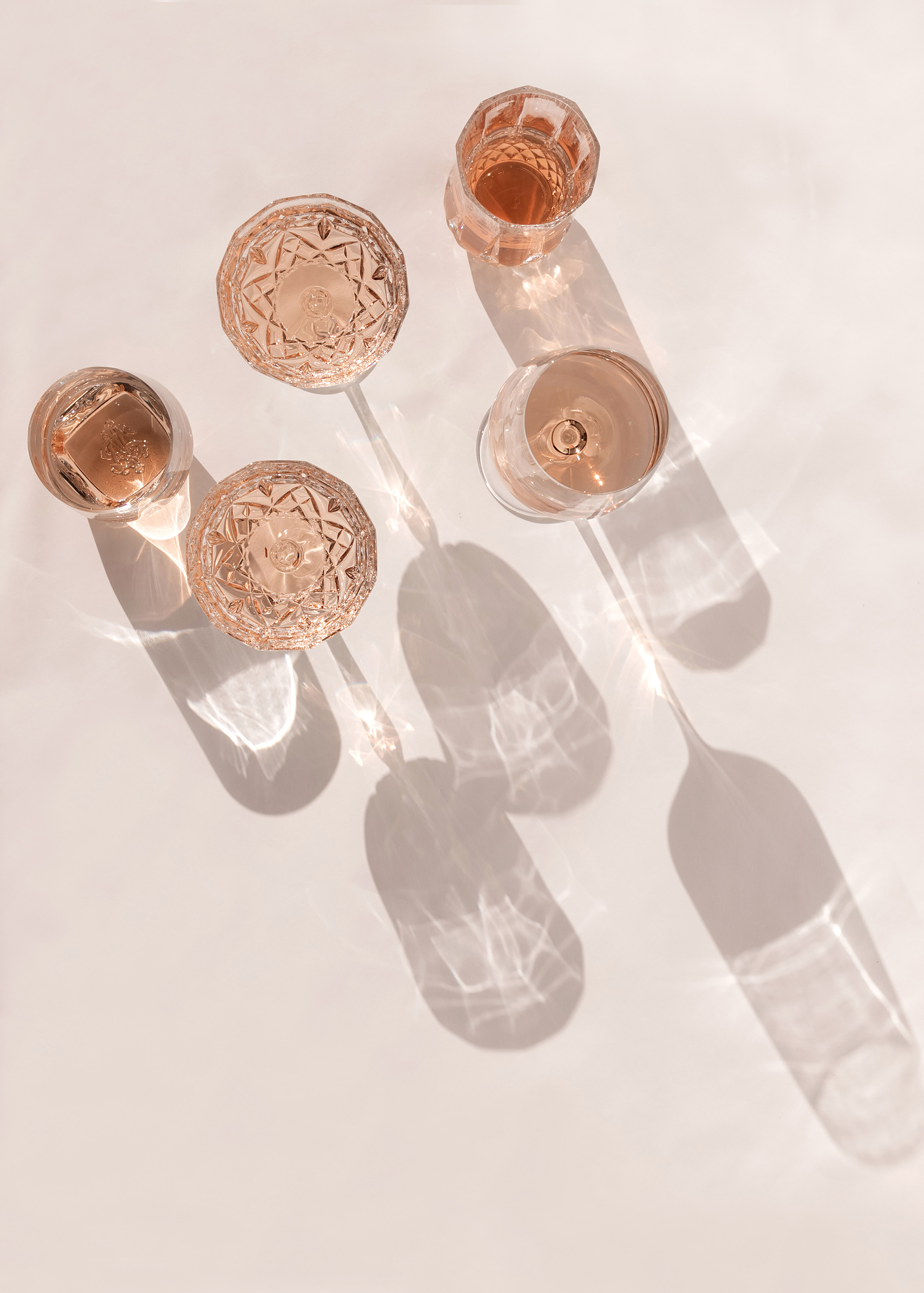 three wine glasses are shown on a white surface